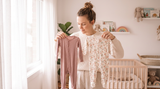 Parent comparing bamboo and cotton baby sleepers side by side