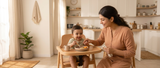 Baby starting solids with mother during mealtime.