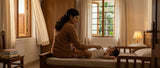 Mother checking her baby’s comfort in a warm Kerala bedroom.